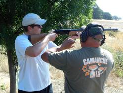 An instructor coaching a shooter